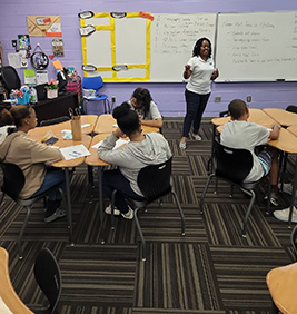 Students engaged in teacher lecture