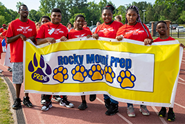 Students holding Rocky Mount Prep Pride banner at Special Olympics
