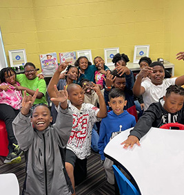 Students smiling at tables