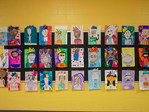 Student portrait artwork displayed on the wall