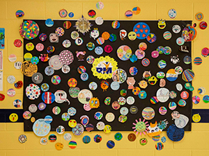 Wall full of colorful student artwork