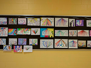 Artistic representations of names displayed on the wall