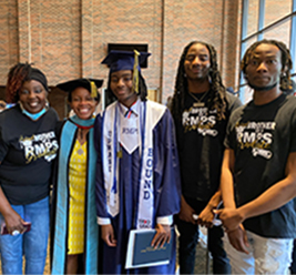 Dr. Garrett with graduating student and his family